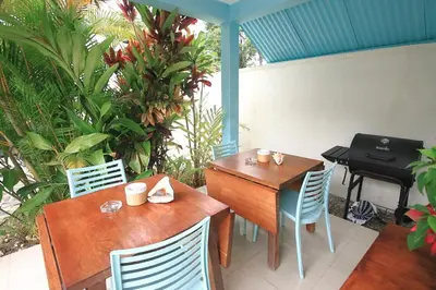 a patio with two tables and chairs and a grill at Residence Las Dos Palmas in Las Terrenas