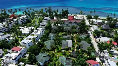 an aerial view of a city with houses and the ocean at Las Palmas Eco Residence in Las Terrenas