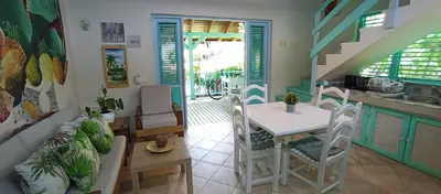 a kitchen and dining room with a table and chairs at Las Palmas Eco Residence in Las Terrenas