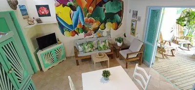 a living room with a table and a television at Las Palmas Eco Residence in Las Terrenas