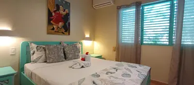 a bedroom with a bed with a towel on it at Las Palmas Eco Residence in Las Terrenas