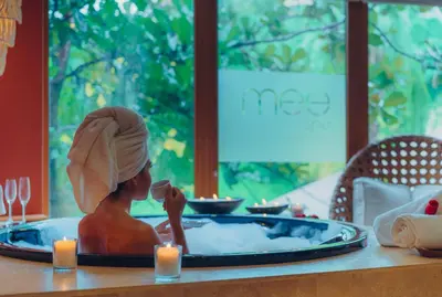 a statue of a woman sitting in a bath tub at The Bannister Hotel & Yacht Club by Mint in Santa Bárbara de Samaná