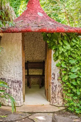 an open door of a house with a bench in it at Natura Cabana Boutique Hotel & SPA by Mint in Cabarete