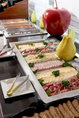a buffet line with many different types of food at Hodelpa Centro Plaza in Santiago de los Caballeros