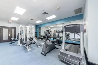 a gym with treadmills and machines in a room at Hodelpa Garden Court in Santiago de los Caballeros