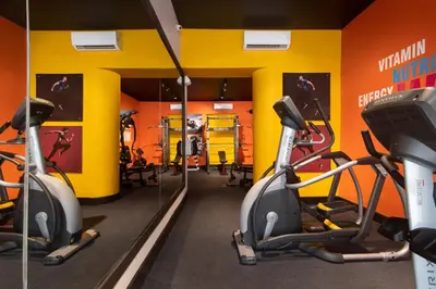 a gym with two treadmills and exercise bikes at Hodelpa Caribe Colonial in Santo Domingo