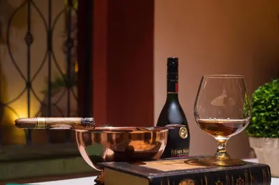 a bottle of wine and a glass on a table at Hodelpa Caribe Colonial in Santo Domingo