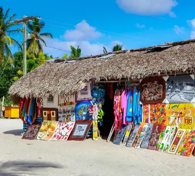 a store on the beach with a straw roof at Hotel Olimpo in La Romana