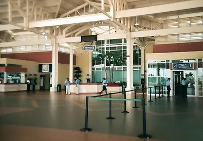 a large building with people walking around in an airport at Hotel Olimpo in La Romana