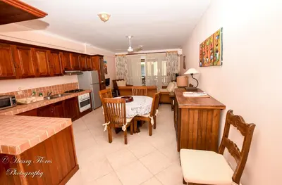 a kitchen and dining room with a table and chairs at Palma Real in Bayahibe
