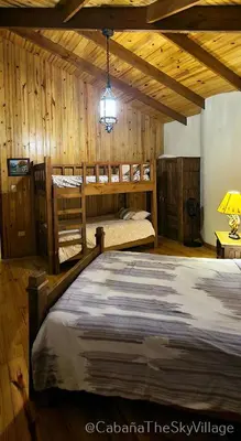 a bedroom with two bunk beds and a lamp at Villa The sky village in Jarabacoa