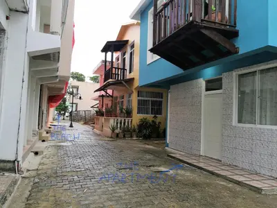 a street with blue graffiti on the side of a building at Apartamento Costa Azul en El Pueblito in San Felipe de Puerto Plata
