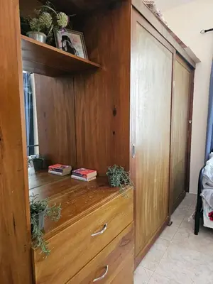 a wooden cabinet with some plants on top of it at Apartamento Costa Azul en El Pueblito in San Felipe de Puerto Plata