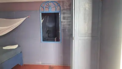 a room with a door and a mirror at Il Triangolo Hostel in Las Galeras