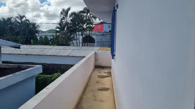 an open door to a balcony with a view of a building at Il Triangolo Hostel in Las Galeras