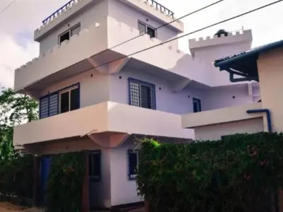 a large white building with a lot of windows at Il Triangolo Hostel in Las Galeras