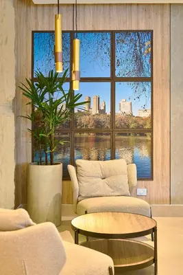 a living room with a large window and a table at Central Park Tower in Santo Domingo
