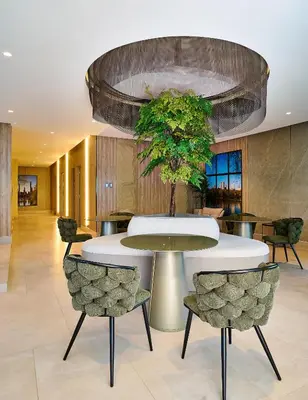 a lobby with a round table and chairs at Central Park Tower in Santo Domingo
