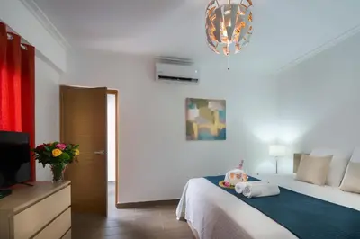 a bedroom with a bed and a flat screen tv at Central Park Tower in Santo Domingo