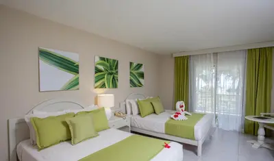 a bedroom with two beds and a window at Vista Sol Punta Cana Beach Resort & Spa - All Inclusive in Punta Cana