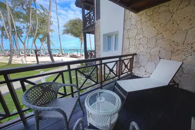 a balcony with a table and chairs and the beach at Vista Sol Punta Cana Beach Resort & Spa - All Inclusive in Punta Cana