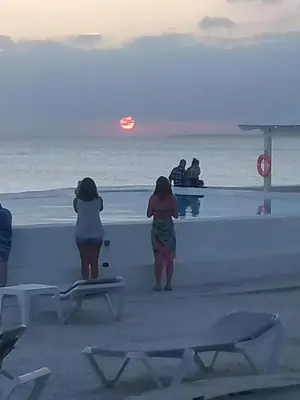 two women standing on the beach looking at the ocean at 1 Sol Dominicus Solo Adultos Habitación con Entrada Independiente y Baño Privado in Bayahibe