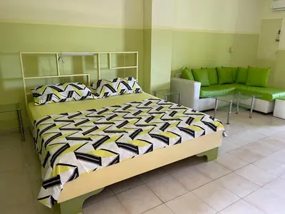 a bedroom with a large bed and a couch at Apartment in Plaza Europa in Sosúa