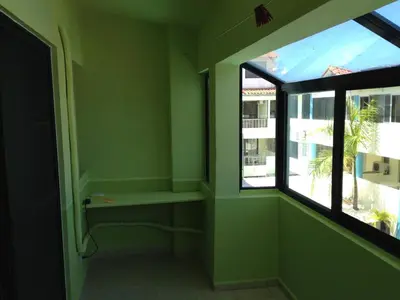 a bathroom with green walls and a window at Apartment in Plaza Europa in Sosúa