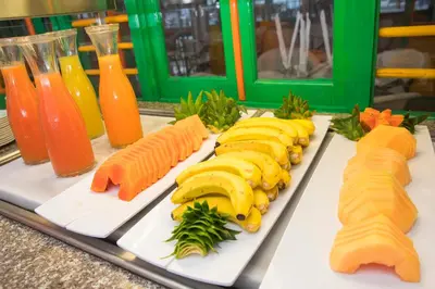 a tray of food with bananas and other foods at Hotel whala!boca chica - All Inclusive in Boca Chica