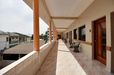 an empty corridor of a building with benches at Hotel Garant & Suites in Boca Chica
