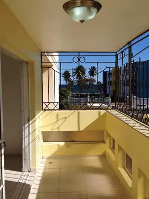 a balcony with a bench and a view of the city at Caribbean Seaview apart Malecon Santo Domingo in Santo Domingo