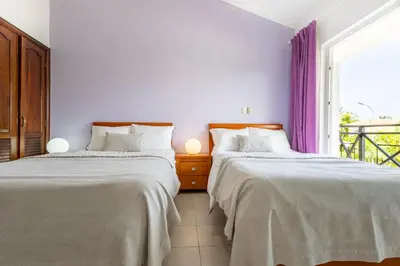 two beds in a room with a window at Private & Luxury Apartment Cocotal in Gated & Secured Community in Punta Cana