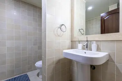 a bathroom with a sink and a toilet at Private & Luxury Apartment Cocotal in Gated & Secured Community in Punta Cana