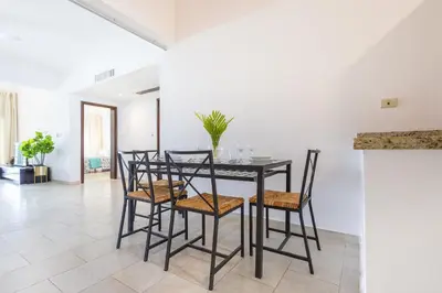 a dining room with a black table and chairs at Private & Luxury Apartment Cocotal in Gated & Secured Community in Punta Cana
