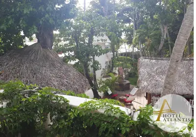 a view of a resort with a thatch roof at Hotel Atlantis in Las Terrenas