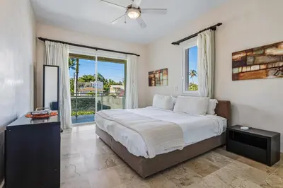 a bedroom with a large bed and a large window at Watermark Luxury Oceanfront Residences in Cabarete