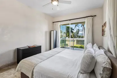 a bedroom with a large bed and a window at Watermark Luxury Oceanfront Residences in Cabarete