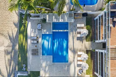 an overhead view of a swimming pool next to a building at Watermark Luxury Oceanfront Residences in Cabarete