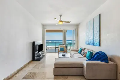 a living room with a couch and a television at Watermark Luxury Oceanfront Residences in Cabarete