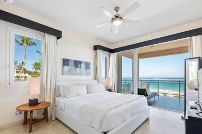 a bedroom with a bed and a view of the ocean at Watermark Luxury Oceanfront Residences in Cabarete