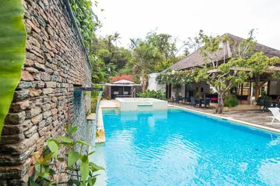 a swimming pool in front of a house at Monserrat Residences in Las Terrenas