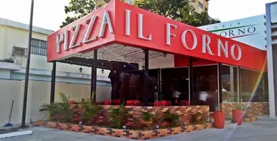 a restaurant with a red sign on top of it at Cozy apartment in exclusive area Bella Vista in Santo Domingo