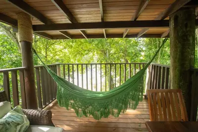 a hammock on the deck of a porch at Platon Ecolodge in Santa Cruz de Barahona