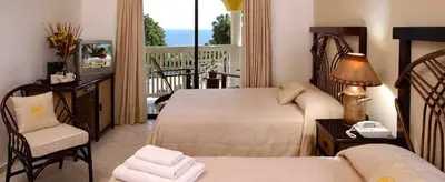 a hotel room with two beds and a balcony at Junior Suite in Puerto Plata at Lifestyle Holidays Vacation Club in San Felipe de Puerto Plata