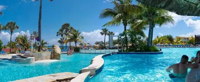 a swimming pool at a resort with palm trees at Junior Suite in Puerto Plata at Lifestyle Holidays Vacation Club in San Felipe de Puerto Plata