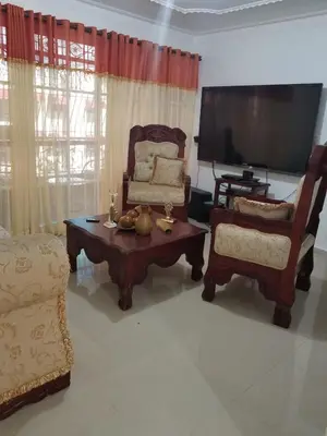 a living room with a tv and a chair and a coffee table at Paradise 3 cerro Altos in Santiago de los Caballeros