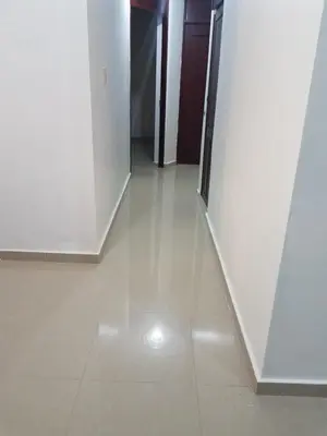 a hallway with white walls and a tile floor at Paradise 3 cerro Altos in Santiago de los Caballeros