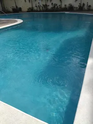 a large swimming pool with blue water at Paradise 3 cerro Altos in Santiago de los Caballeros
