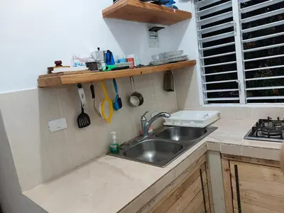 a kitchen counter with a sink and a stove at Villa Coconut in La Verita