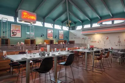 a dining room with tables and chairs in a restaurant at Ocean el Faro Resort - All Inclusive in Punta Cana